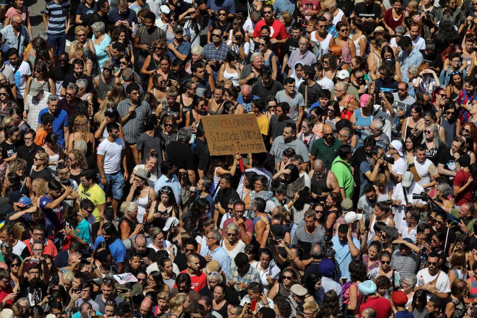  Hundreds march down Las Ramblas in a show of defiance one day on from the atrocity