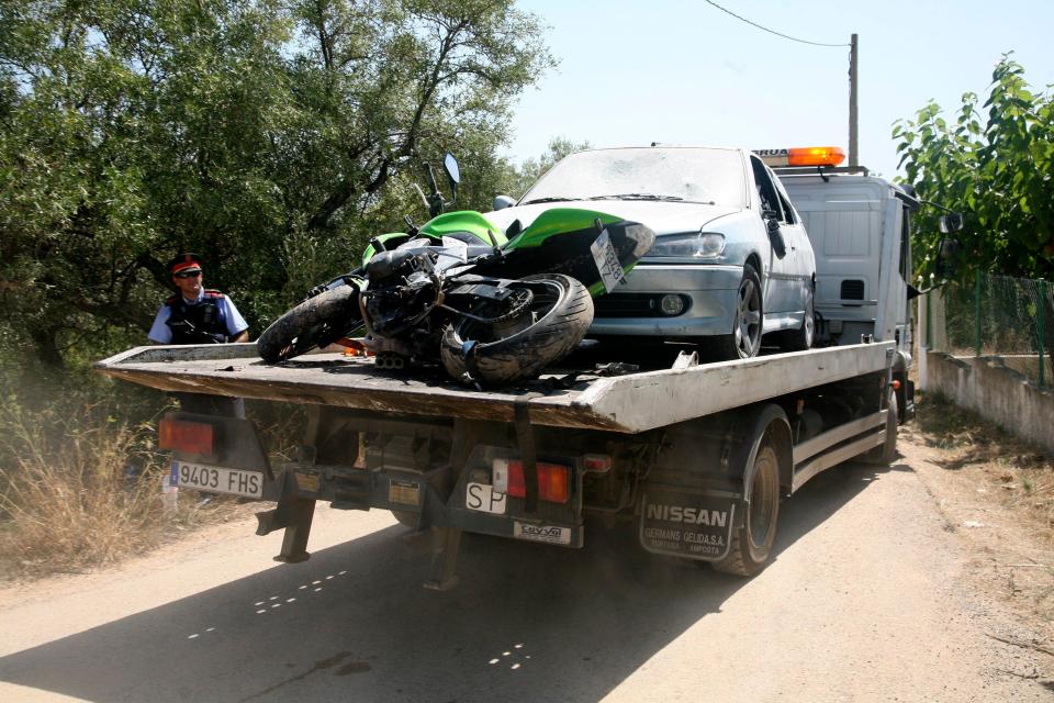  A tow truck removes a motorbike and a car seized in the surroundings of the destroyed house in Alcanar