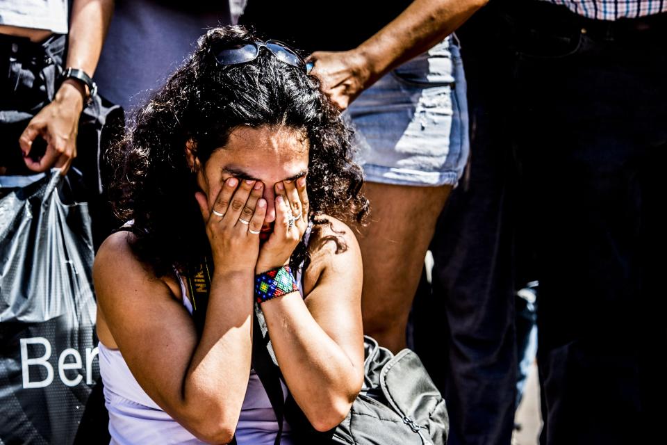  A woman hides her face sh she grieves at Las Ramblas in Barcelona