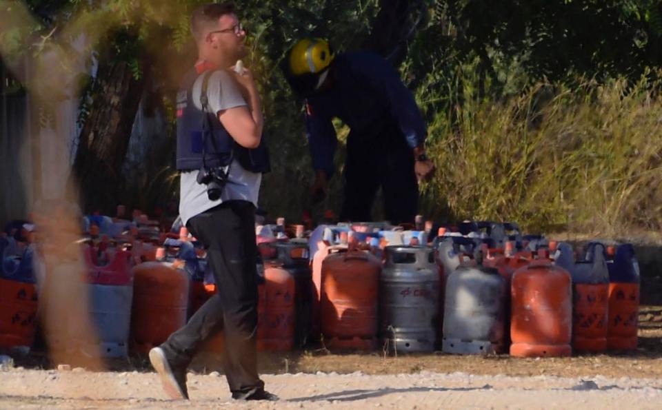  A policeman walks past dozen of gas bottles in Alcanar during a search linked to the Barcelona and Cambrils attacks