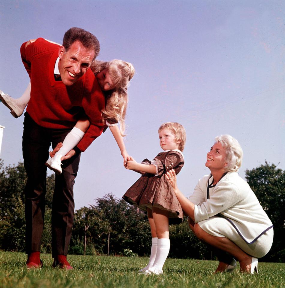  Brucie playing with his two daughters and wife Penny