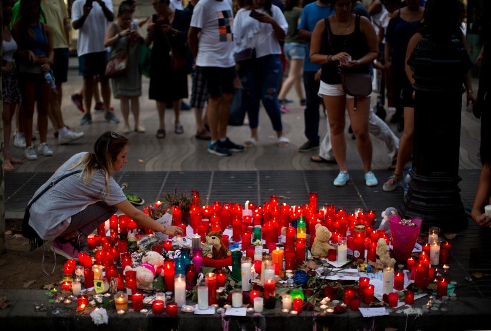  A woman lights candles on a memorial for the victims of the Las Ramblas attack