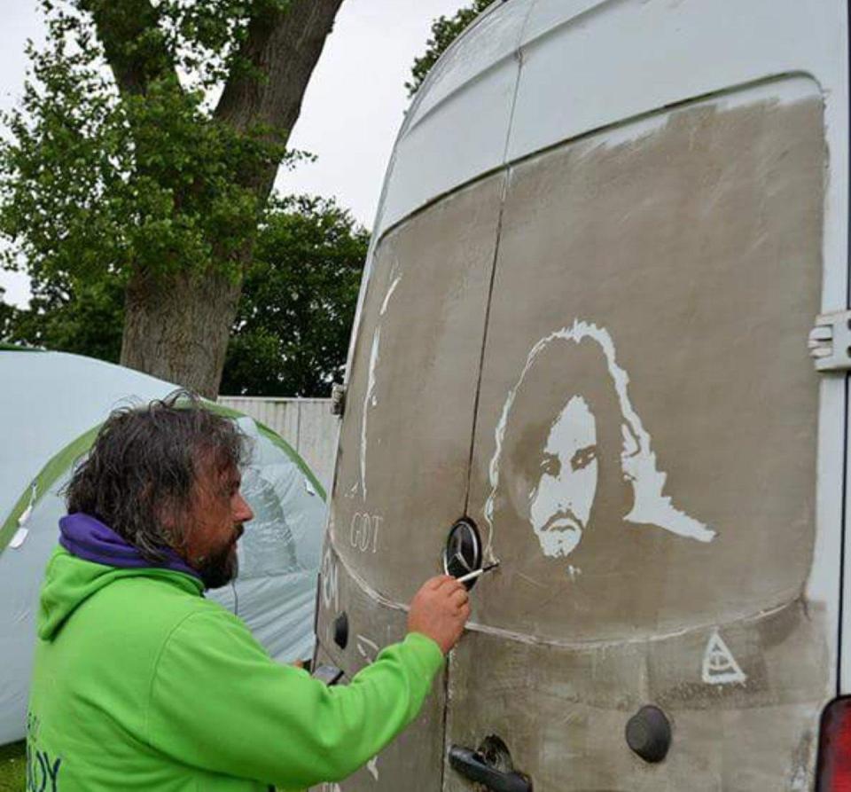  The back of a filthy van is his canvas