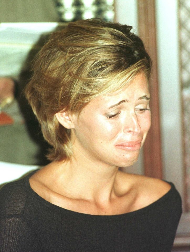 Kelly Fisher crying at a press conference announcing her lawsuit 