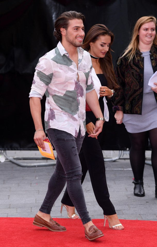 Kem and Amber hold hands as they arrive on the red carpet