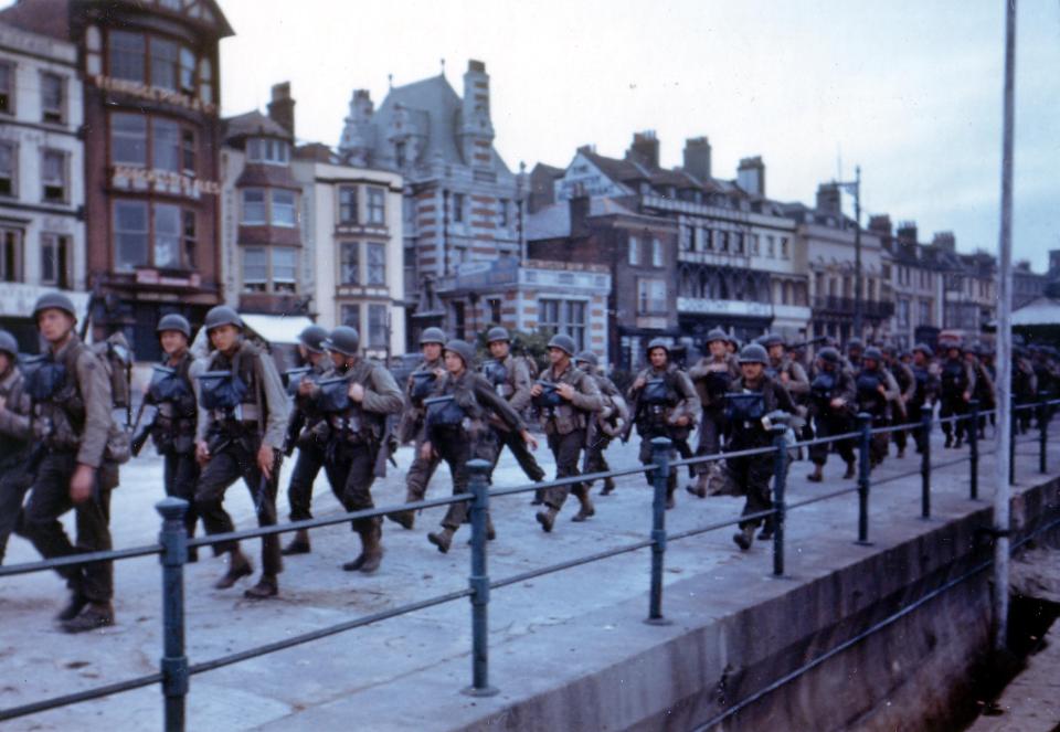  Troops march along the seafront in Weymouth before departing for the Normandy beaches