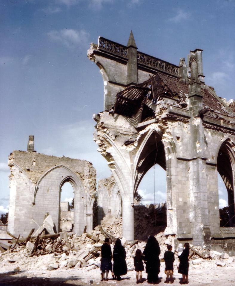  The human scale of the devastation is brought home in one image where a pair of nuns and children gaze at the ruins of a Saint Malo church