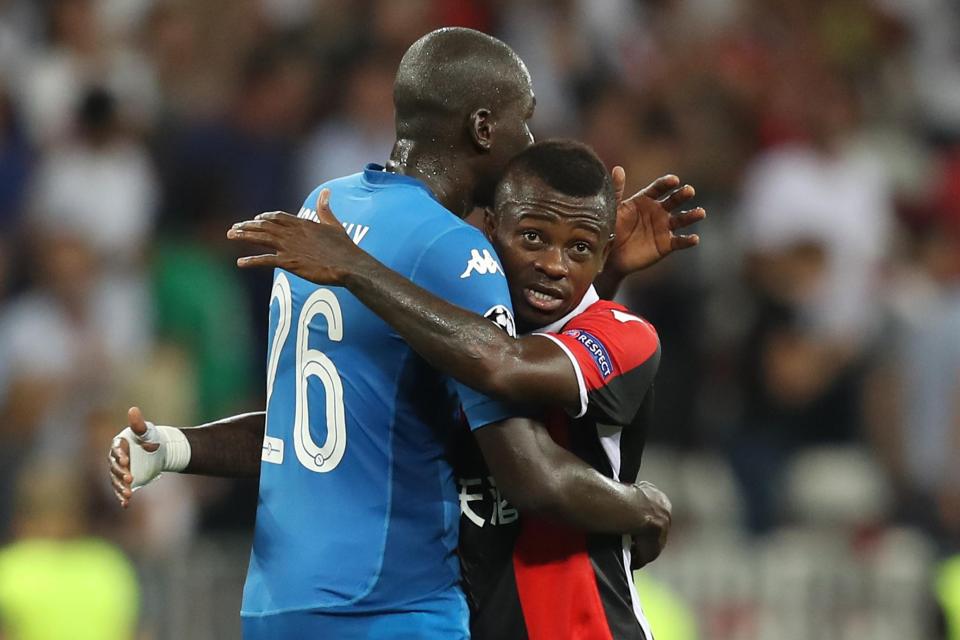  The Ivorian midfielder hugs defender Kalidou Koulibaly after the Champions League play-off match between Nice and Napoli