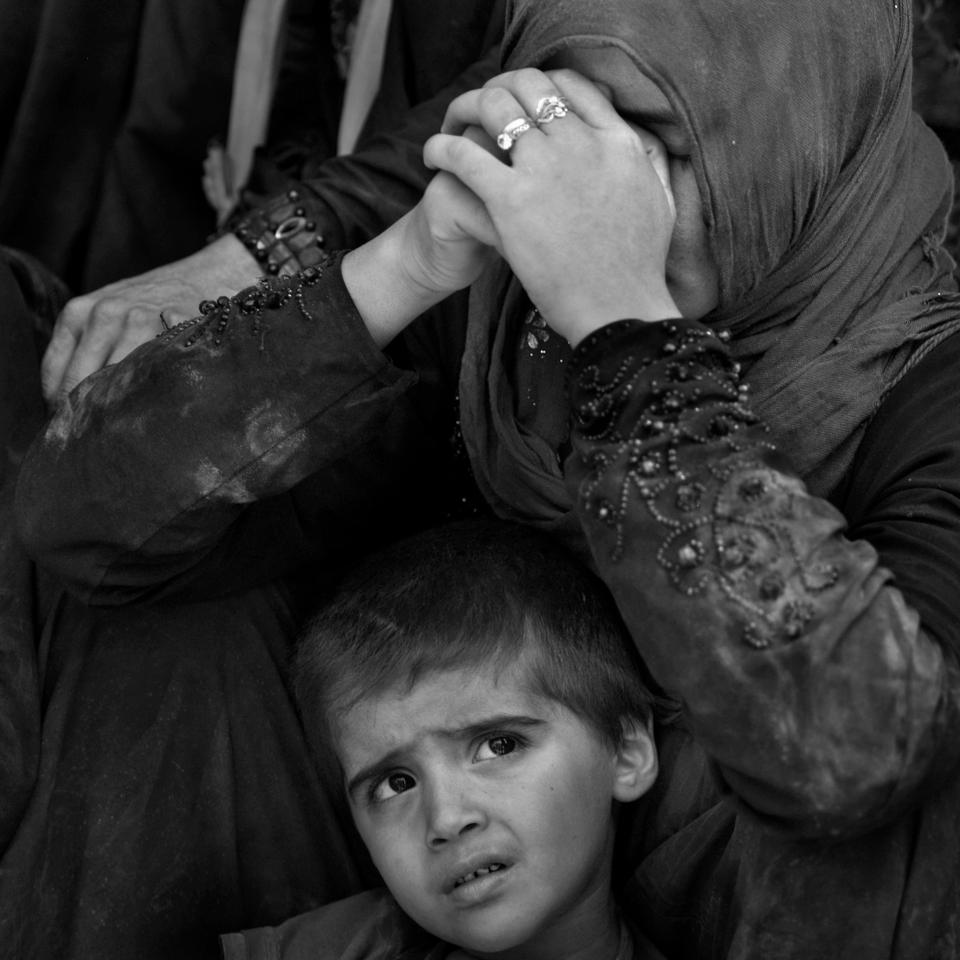  A woman and a young child are pictured in the ruins of Mosul's Old Town