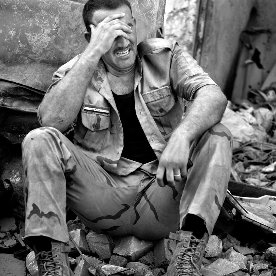  An Iraqi Army soldier weeps at the loss of his cousin near the front line in the continued battle with ISIS in West Mosul amid ruins of the city. Later that night people and soldiers celebrated as here have been announcements that the battle is over and Mosul is liberated but fierce fighting remained in a remaining area.