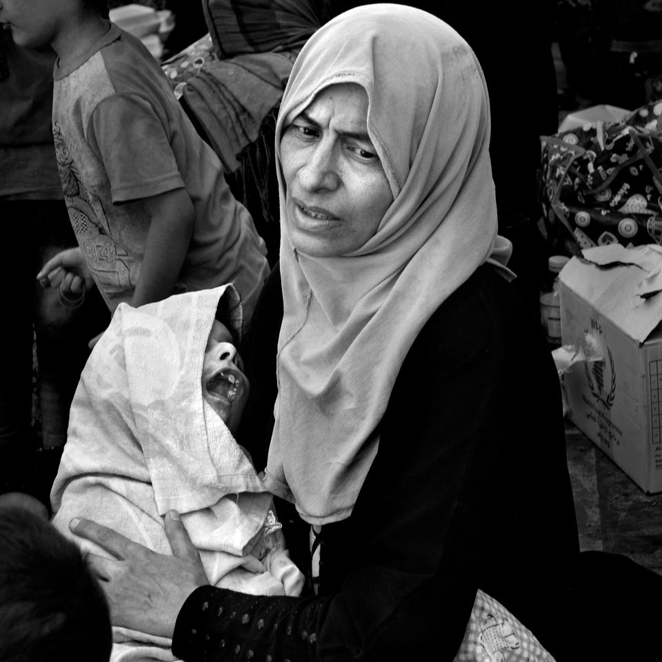  A woman named ALIA holds the body of her 12-year-old child ULA who passed away on the truck to a Trauma Stabilization Point two hours previously. She said it was from lack of food and water as they were trapped in the Old City during the battle with ISIS. Her husband died from a mortar. She clutched the tiny body and would not let medics take her, hoping to bury her child with relatives in East Mosul.