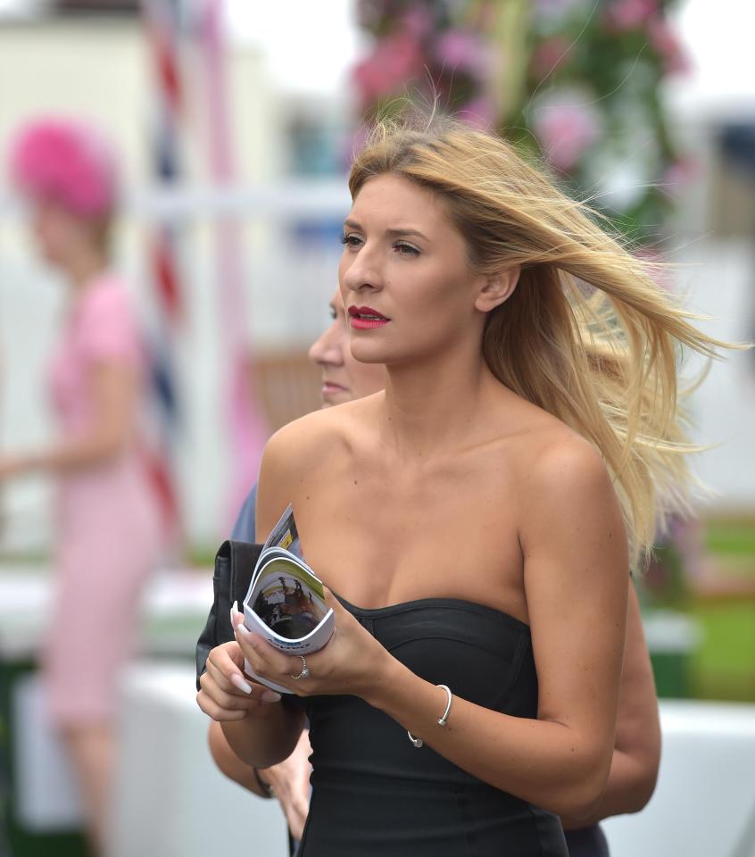  A blonde-haired racegoer braved the unseasonably cold weather in a strapless black dress