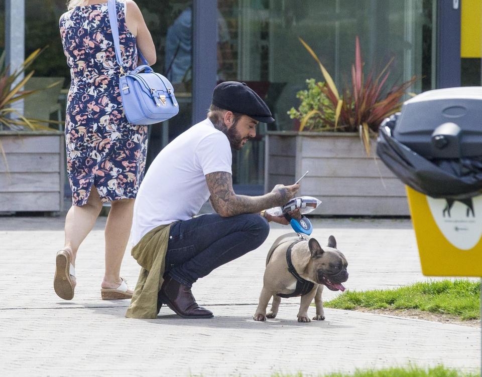  Pete Wicks looks at his phone as he leaves the dog's centre in Essex