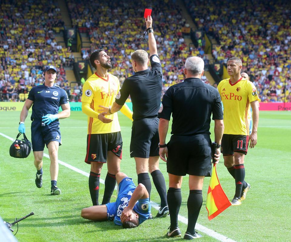  Britos debates with the referee over the red card