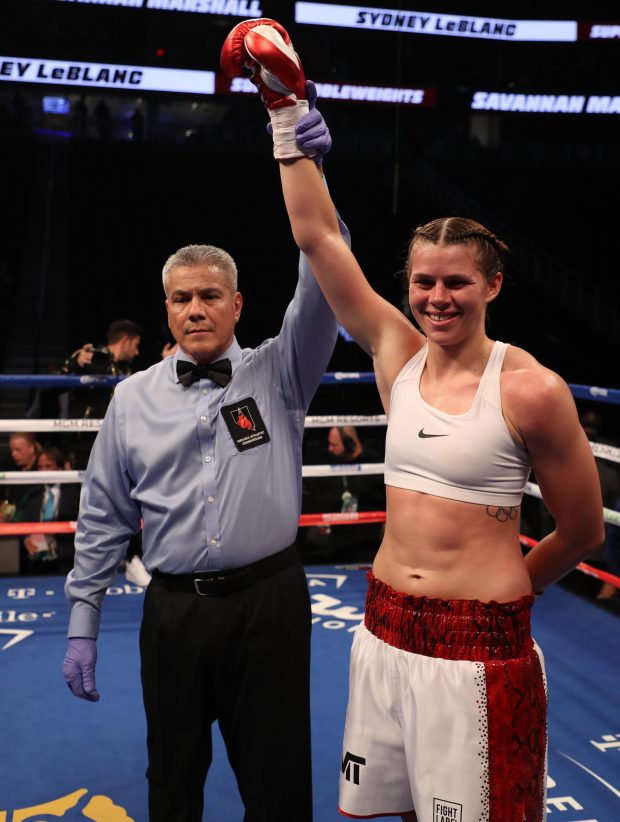 The referee holds Savannah Marshall's arm aloft after she beat Sydney LeBlanc