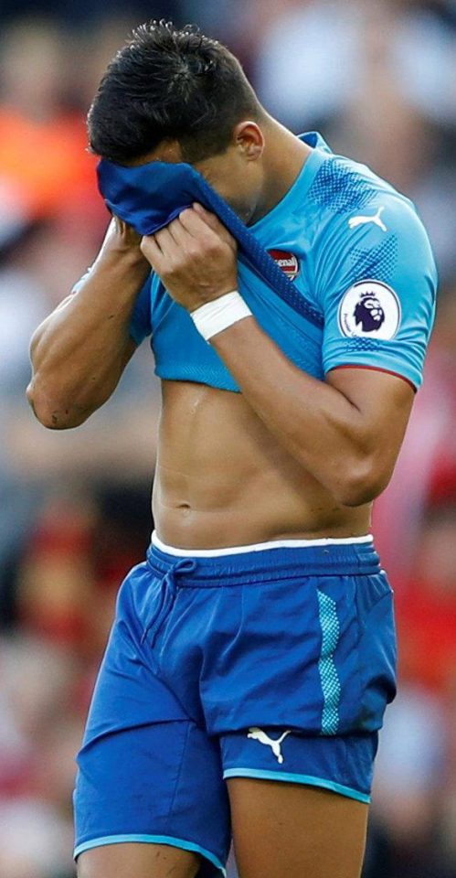  Alexis Sanchez reacts to being substituted by putting his shirt over his head