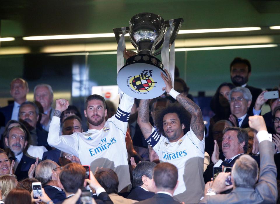  He lifts aloft the trophy with left-back Marcelo at the Bernabeu Stadium