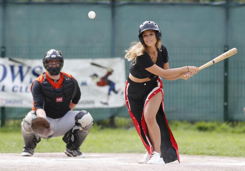  Chloe Lewis went for some glam sports gear of black and red tracksuit bottoms that were split at the side