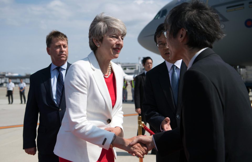  Theresa May is greeted by dignitaries as she arrives