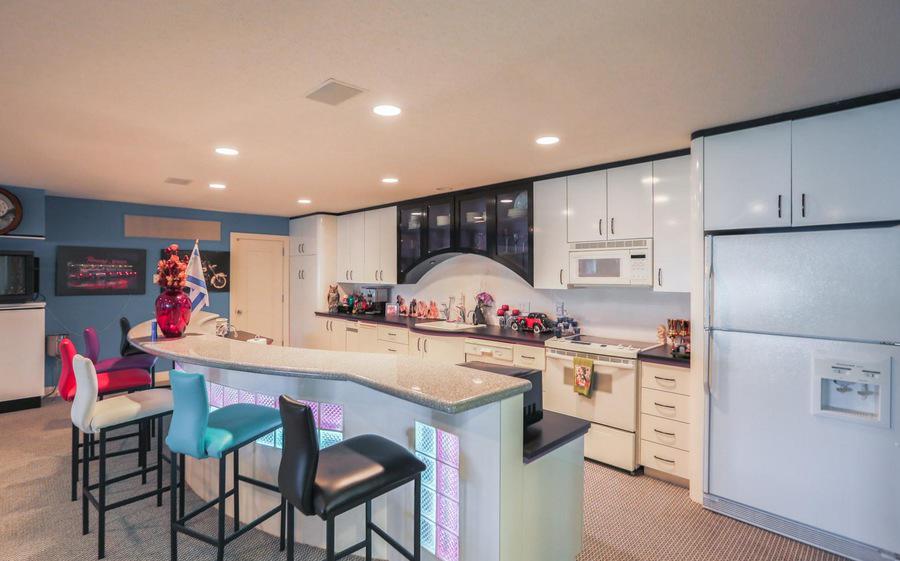 The kitchen features all the mod cons - and some ugly bar stools