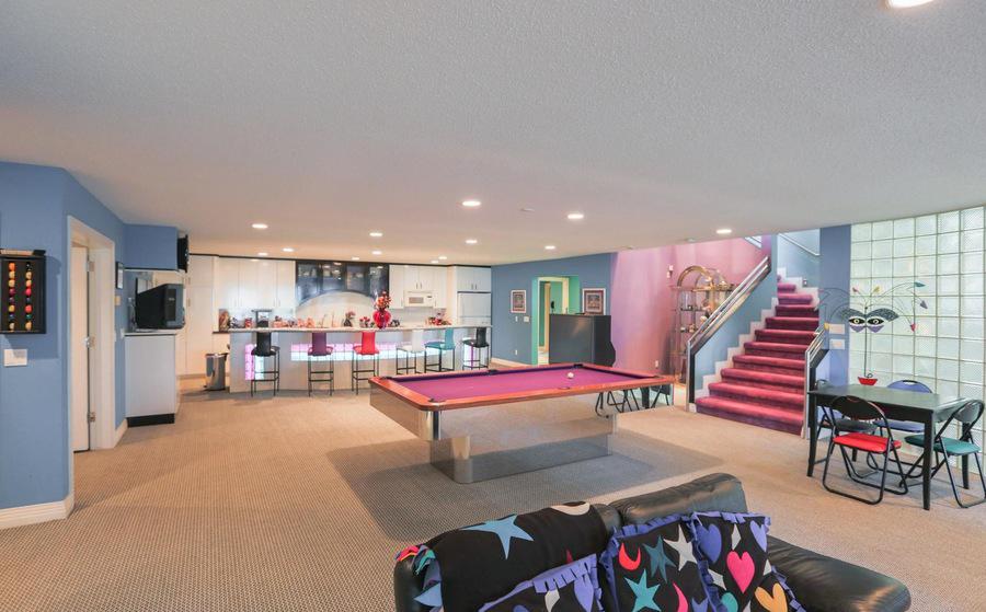 The family also get to enjoy a game of pool on this pink table