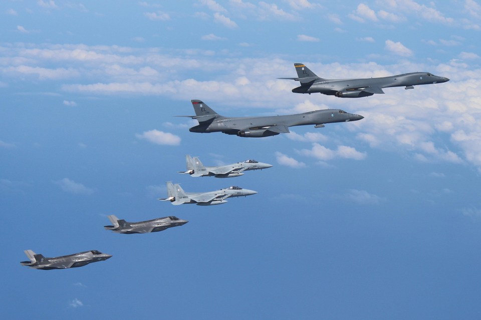 Two B-1Bs fly from Guam with an escort of a pair of Japanese F-15s and US Marines’ F-35B fighter jets