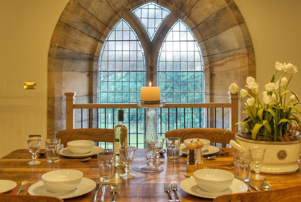  Victorian stained-glass window and Gothic archway makes for a powerful view from the dinner table