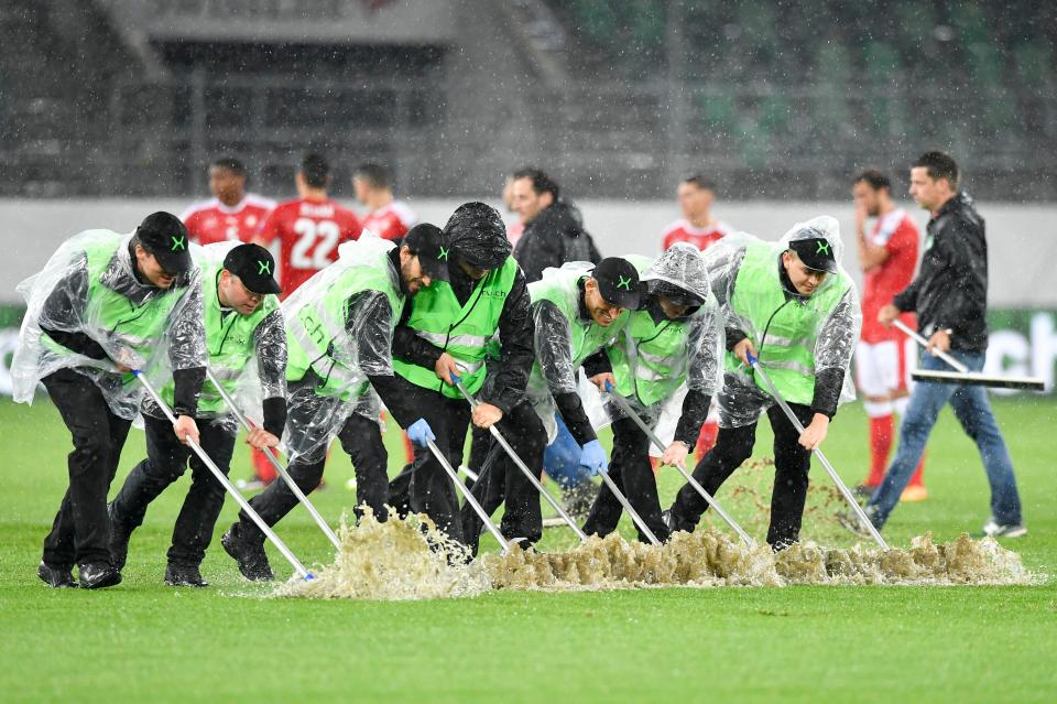  Workers attempted to brush away the water