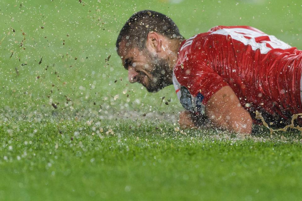  Eren Derdiyok got a facefull of rain water when he slipped