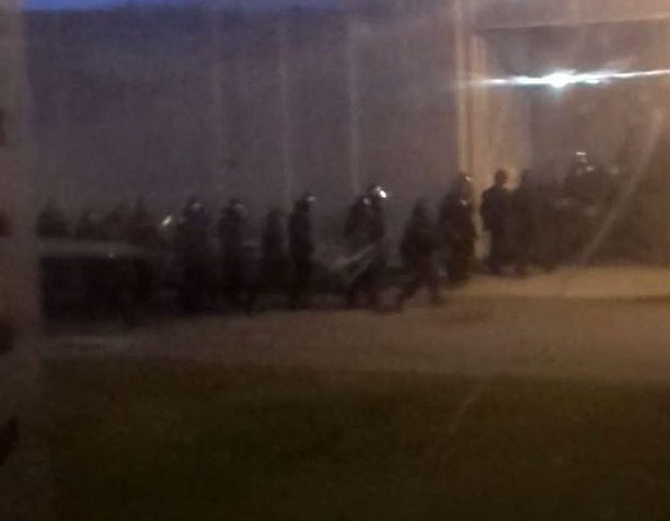 Footage shot across a yard shows anti-riot officers entering The Mount jail in Bovington, Herts