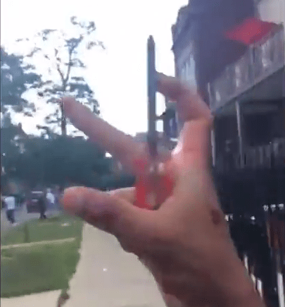  The video shows the bloodied man clutching a screwdriver and making what appears to be a gang sign