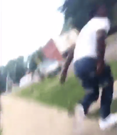  A bystander is chased across the road by the man filming the incident