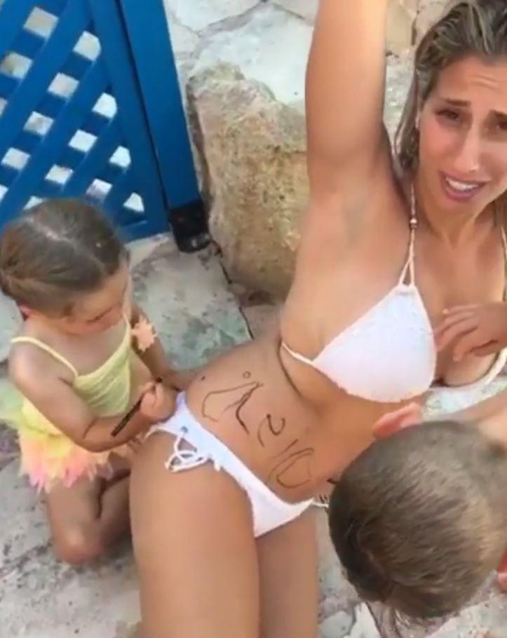  She then had her son and a little girl draw her stretch marks on in black pen