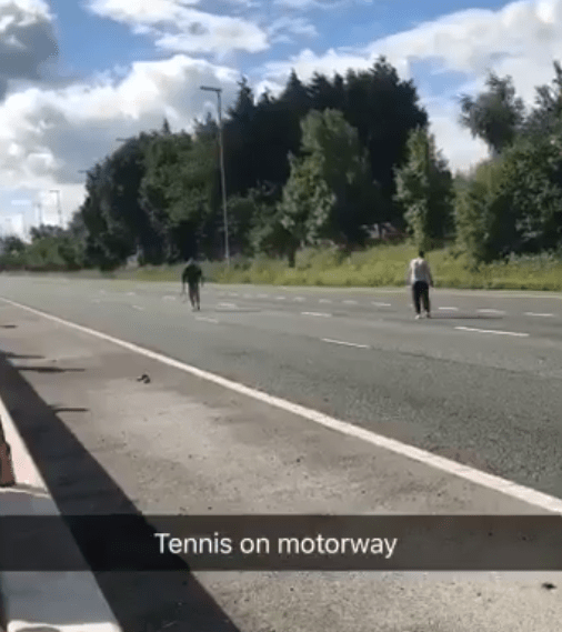  This bizarre video showed two men playing tennis on a deserted M6 motorway as others look on