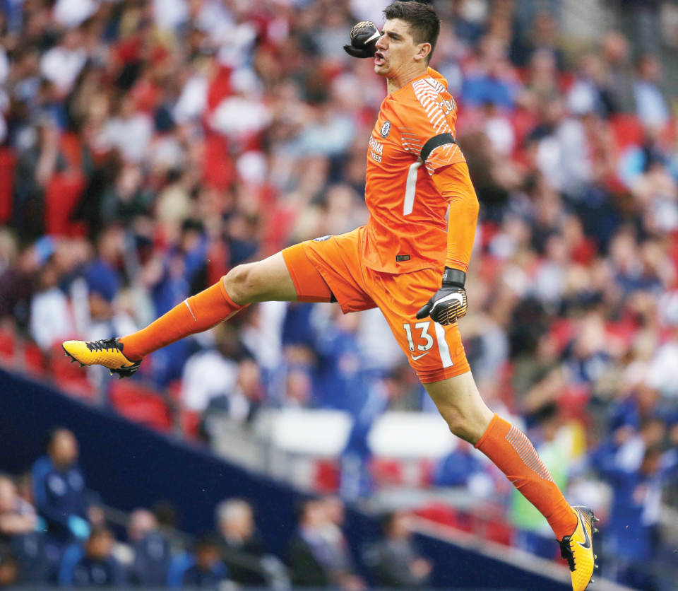  Thibaut Courtois celebrates victory at Wembley - and believes Chelsea were helped by the less intimate atmosphere at Wembley for hosts Tottenham