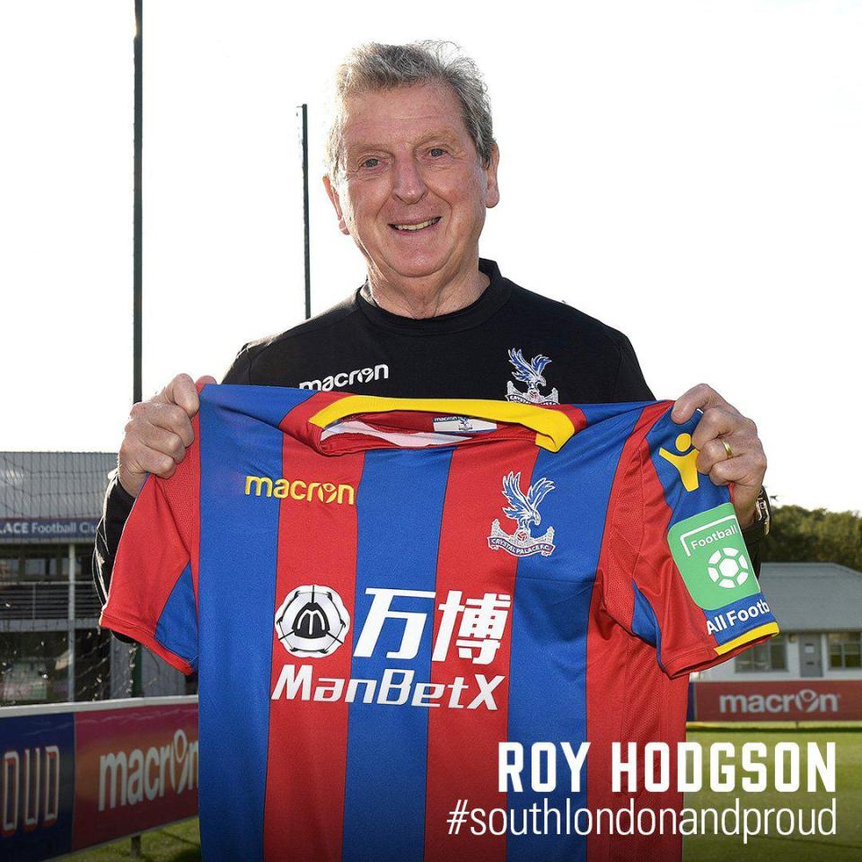 Roy Hodgson holds up a Crystal Palace shirt after his appointment