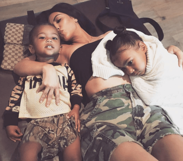  Kim, pictured with kids Saint and North, claims the robbery made her less materialistic