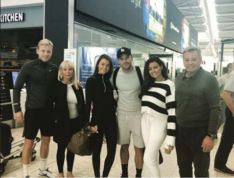  Mark Wright posed for a picture with his family at the airport - and his mum Carol, second left, looked heartbroken