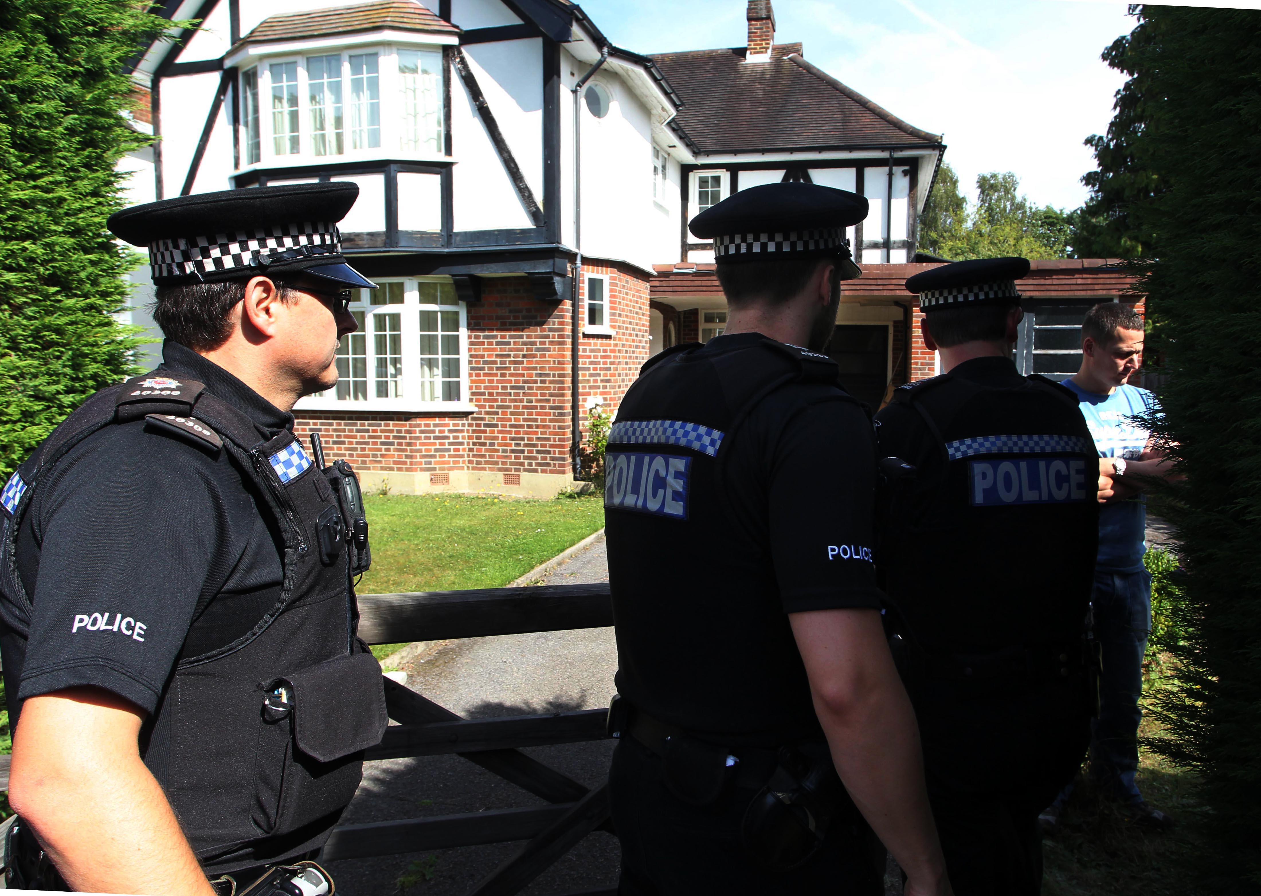 Police outside the Surrey home of the al-Hilli family following their murders