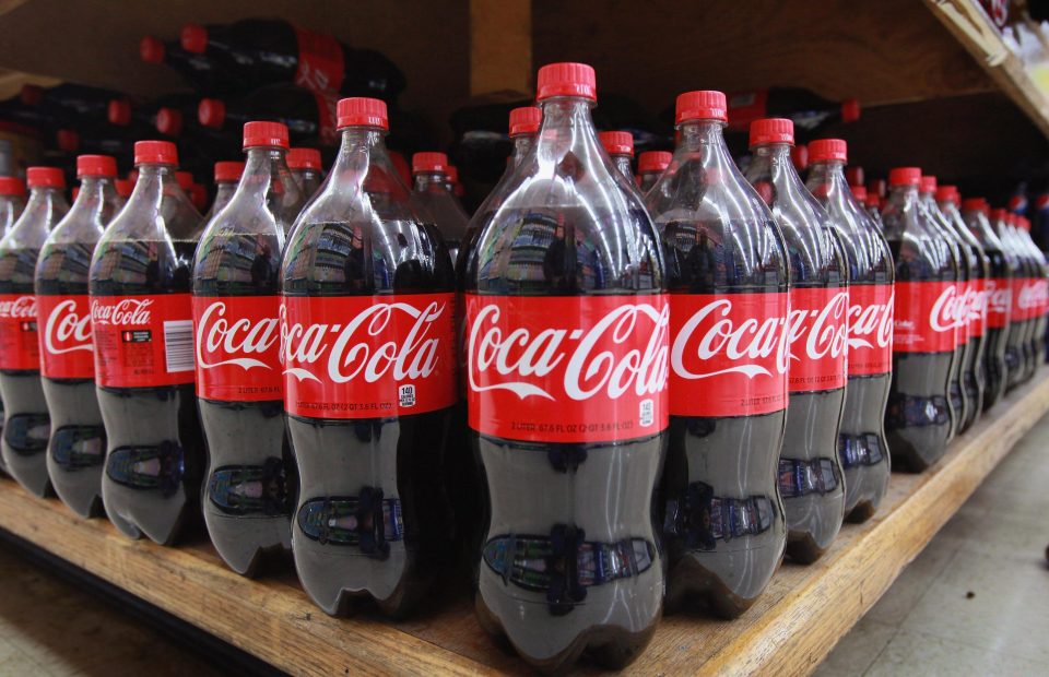  Coca-Cola is to make its bottles smaller while hiking prices in a bid to beat the sugar tax