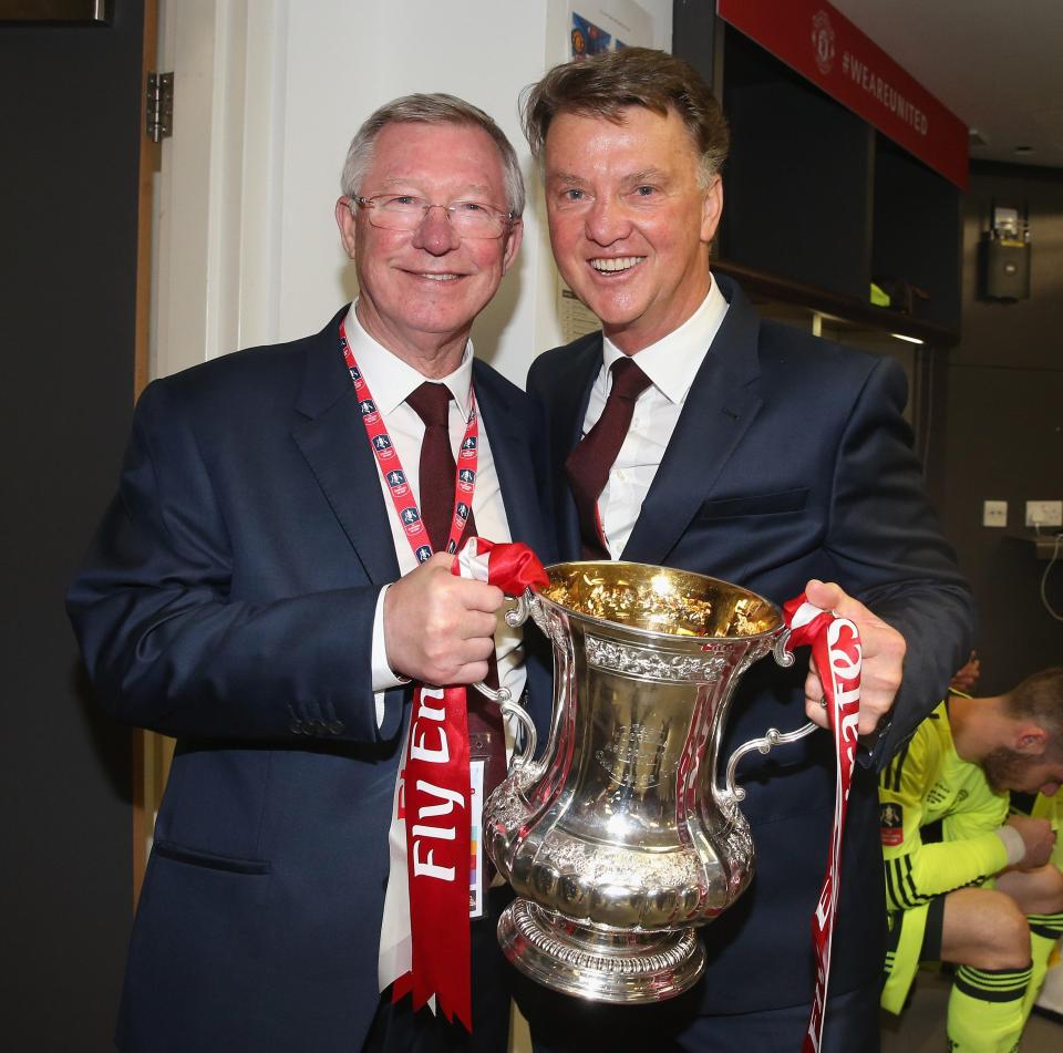  Louis van Gaal poses with Sir Alex Ferguson and FA Cup trophy in 2016