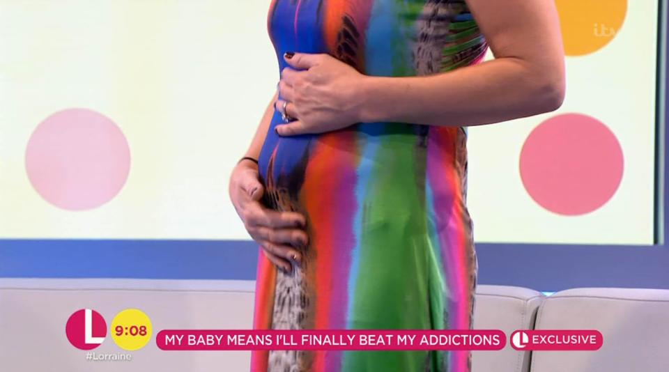  She stood up to show viewers her baby bump at just five weeks