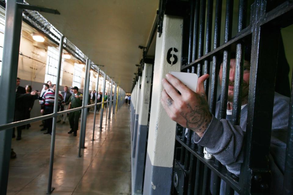  Inmate Joseph Sweet uses his mirror to look at the California Republican lawmakers visiting the inside of Folsom Prison