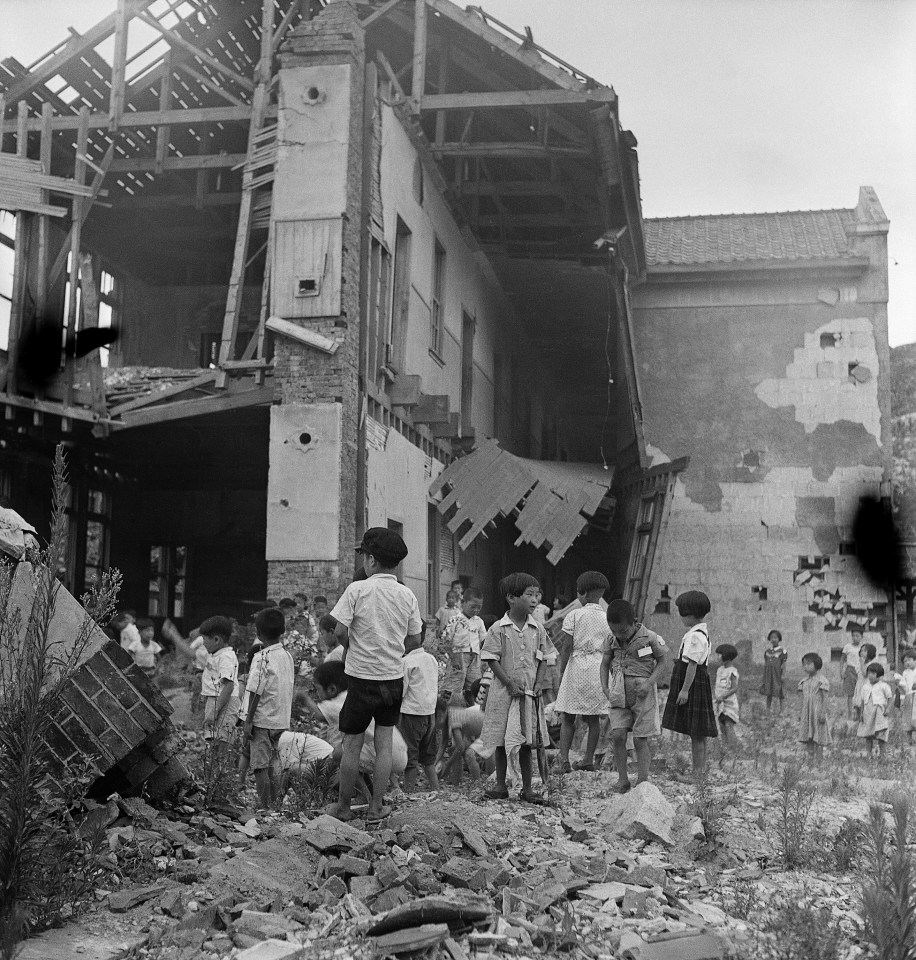 Despite many of the school's buildings being destroyed by aerial bombing, classes go ahead in Seoul in 1952