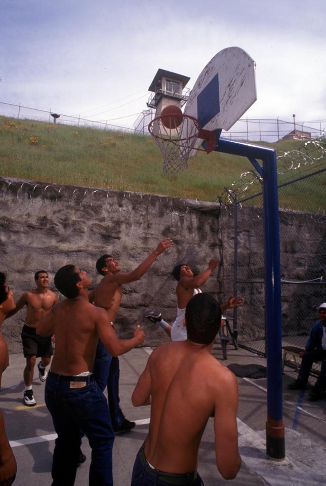  A group of Mexican convicts play a game of basketball in the yard at Old Folsom State Prison