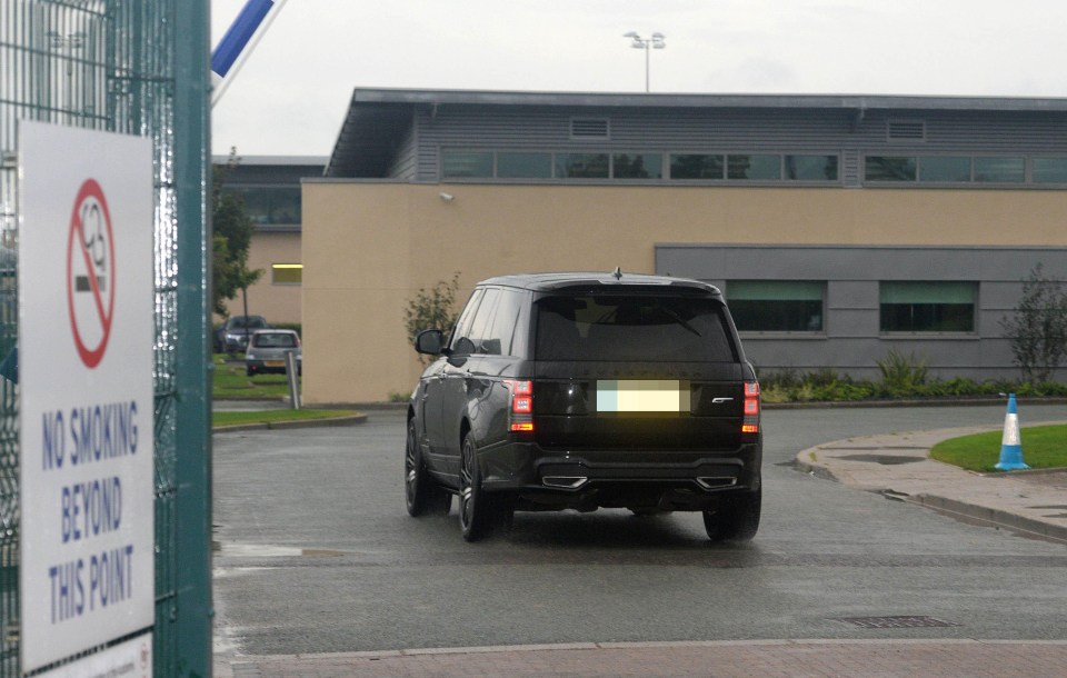 Rooney drives into the Finch Farm training complex this morning