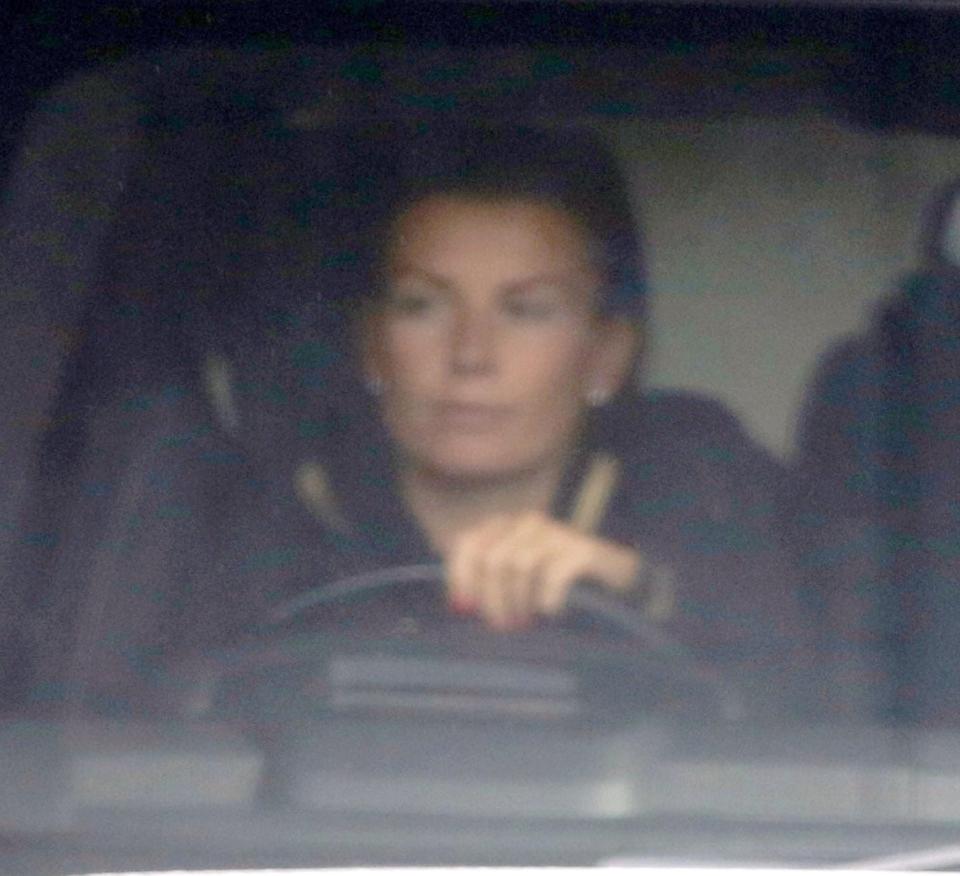  Pregnant Coleen looked glum as she drove through Manchester without her children today