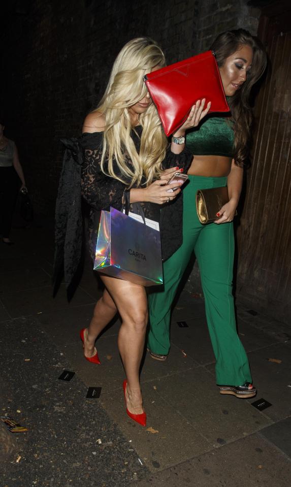  The former Towie star hid her face behind her hair and her clutch bag