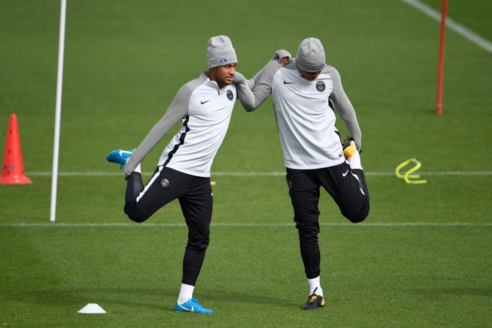  Silva and Neymar stretch out their legs at the Camp des Loges training centre