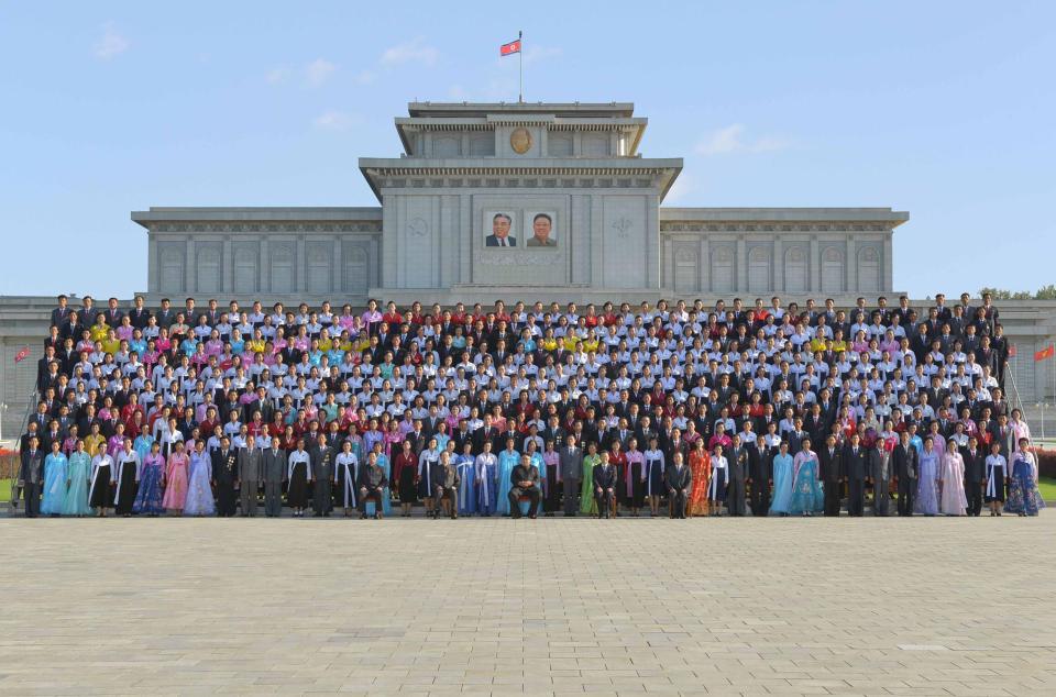  The North Korean leader (front row, C) attending a photo session with the teachers